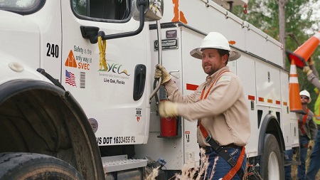 Suwannee Valley Electric Cooperative worker getting in bucket truck Suwannee Valley Electric Cooperative worker getting in bucket truck