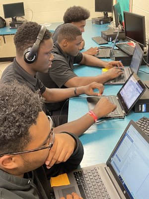 Digital C boys working on computers Digital C boys working on computers