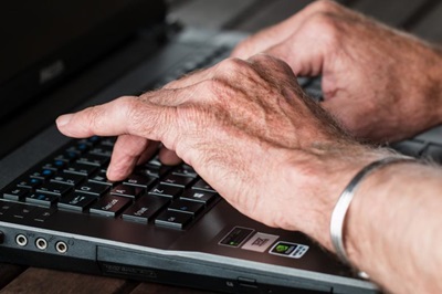 older adult hands on computer older adult hands on computer