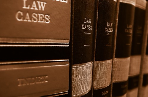 Law books side by side on a shelf